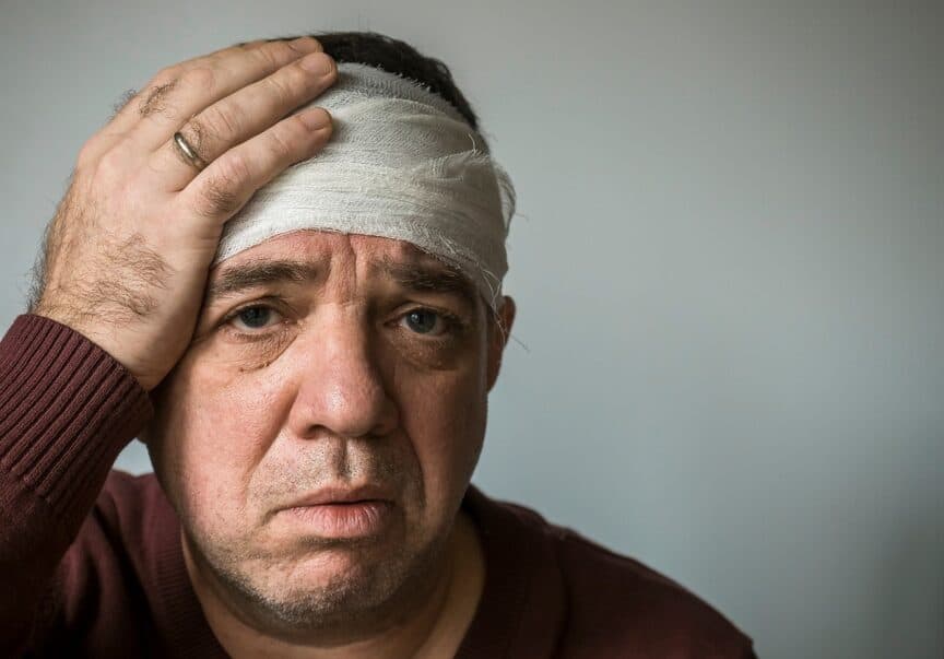 Man with concussion, head injury. His head is bandaged